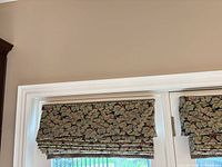 Both Roman shades mounted on patio doors, fabric pattern visible