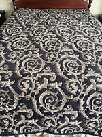 Full view of bedspread on queen bed displaying complete damask pattern