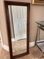 Front view of rectangular mahogany framed mirror