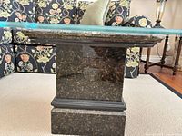 Granite pedestal side view with glass edge visible