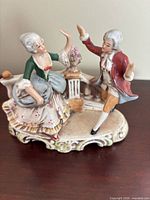 Front view of porcelain figurine showing dancing couple and color details