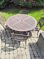 round wrought iron patio table and matching chairs full set view