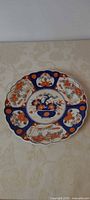 Full view of Imari plate showing scalloped edge and overall design
