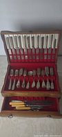 Open cutlery box showing knives in lid, forks in tray, additional knives in drawer