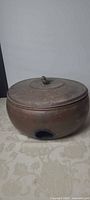 Front view of copper hose pot showing side opening and overall form