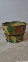 Side view of Awaji bowl showing green-yellow-brown glaze and cylindrical shape