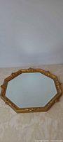 Full view of octagonal mirror showing frame and glass