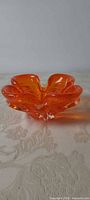 Top angled view of orange Chalet art glass bowl showing signature free-form shape