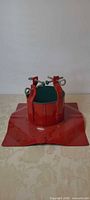 Overall view of red metal Christmas tree stand