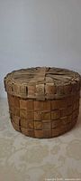 Full view of basket side and lid showing shape and weave