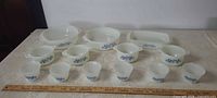 Full group of all milk glass pieces with ruler for scale