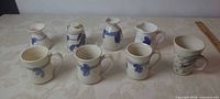 Eight stoneware pieces arranged on table