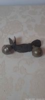 Full view of leather strap with two brass bells