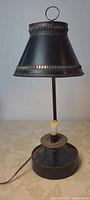 Full view of lamp front, showing shade, pole, base, cord