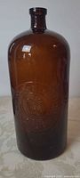 Full view of amber glass bottle showing shape and color