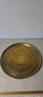 Full view of round brass tray showing size and overall condition