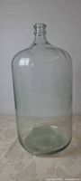 Full view of glass carboy standing upright