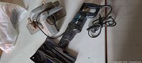Mastercraft reciprocating saw and Black & Decker circular saw side by side with cords