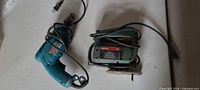 Bosch jigsaw and Makita drill side by side showing overall condition