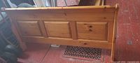 Footboard showing pine wood, panel design, sleigh curve
