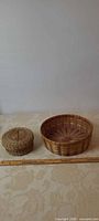 Both baskets side by side with ruler for scale