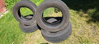 All four tires stacked to show quantity and general condition