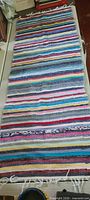 Full view of the rag rug runner showing length and multicolour stripes