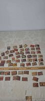 Wide view of all matchbox covers arranged with ruler for scale