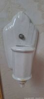 Front view of porcelain wall sconce showing shape and socket