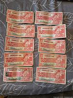 Front view of ten 10¢ Canadian Tire Money notes showing Sandy McTire portrait and serial numbers