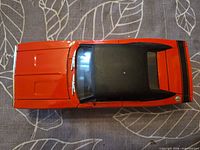 Top view of red Dodge Charger diecast showing black roof and hood detail