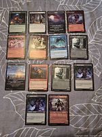 Full lot overview – 16 cards shown, two are day/night indicators, 14 are the trading cards offered