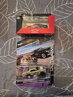 Front view of both packaged diecast cars