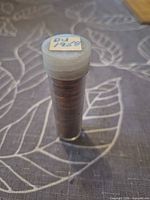 Full view of coin roll in plastic tube