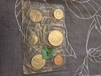 Front of sealed 6-coin set in plastic pouch