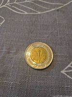 Commemorative 1945-2020 V-E Day toonie showing torch design