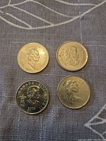 Obverse of four Canadian commemorative quarters