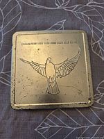 Closed metal tin showing dove design and wear