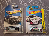 Front view of both Hot Wheels blister packs showing car models and artwork