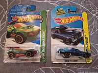 Front view of both carded Hot Wheels showing models and series.