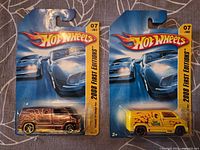 Front view of both Hot Wheels 2008 First Editions Custom '77 Dodge Van sealed packs
