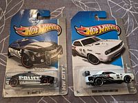Front view of both blister-packaged Hot Wheels cars