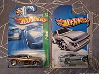 Front of both blister-carded Hot Wheels models