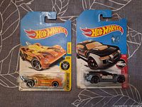 Front of both carded Hot Wheels cars