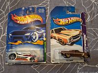 Front view of both packaged Hot Wheels cars