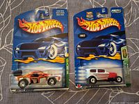 Front view of both Hot Wheels cars in blister packaging