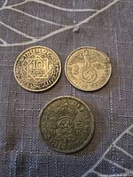 Obverse sides of Morocco 10 Francs, Germany 2 Reichsmark and United Kingdom two shillings coins