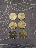 Six coins arranged in two columns, three rows, showing reverse designs