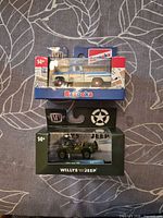 Front view of both boxed diecast vehicles stacked