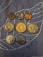 All eight coins arranged in three rows showing obverses
